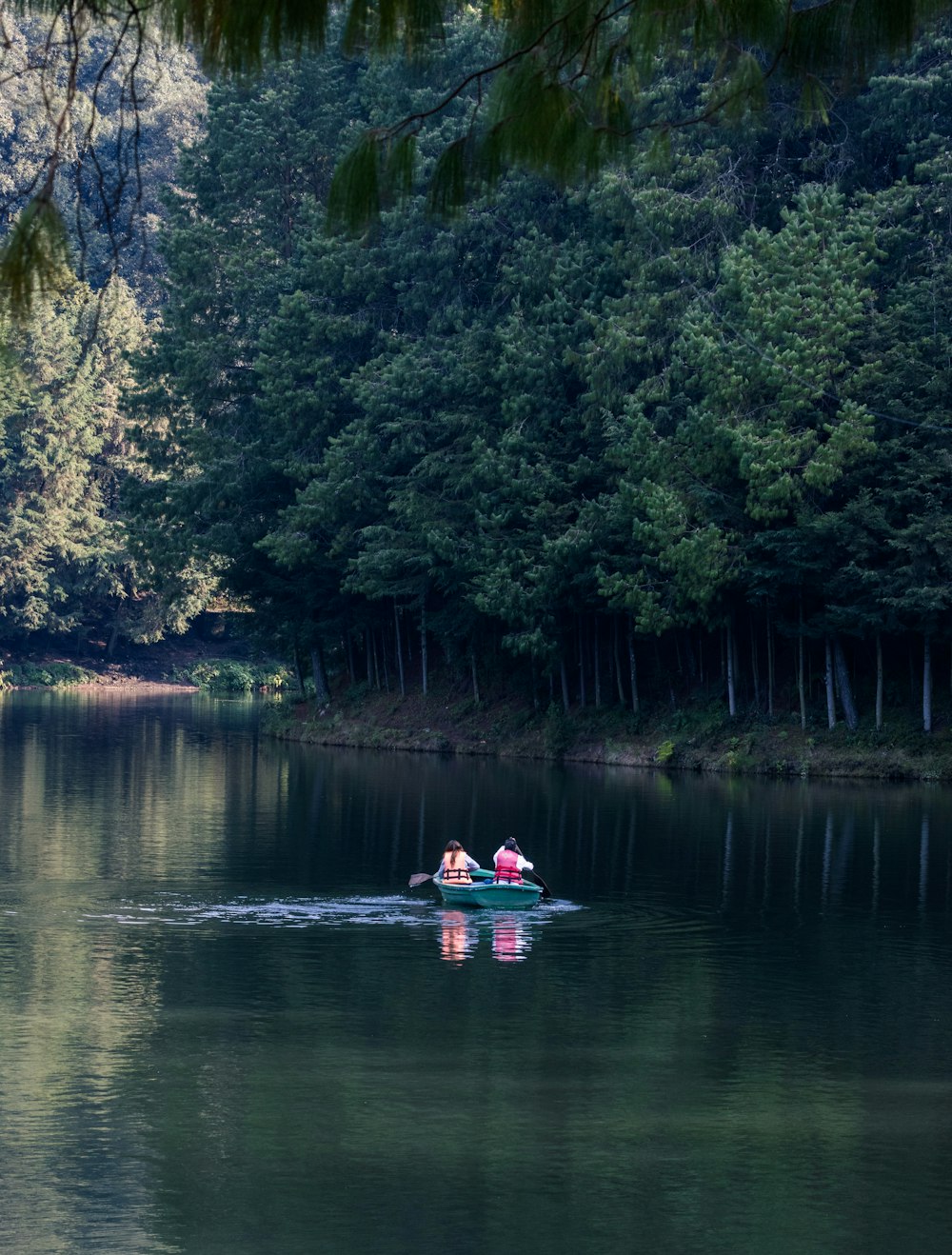 Deux personnes dans un petit bateau sur un lac