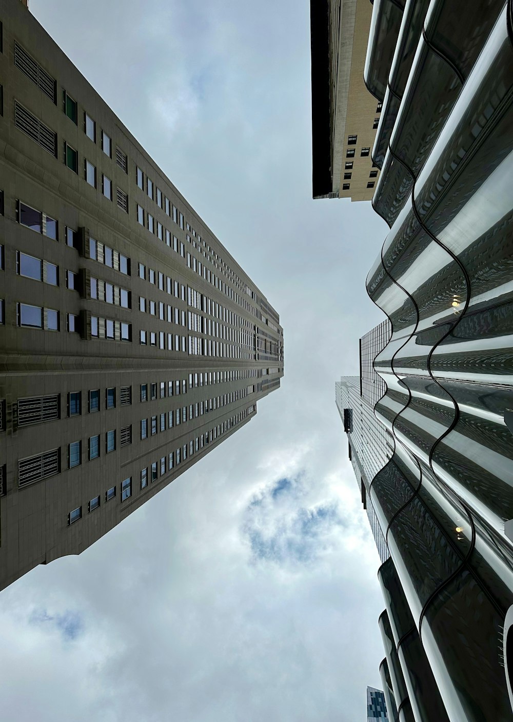 looking up at two tall buildings in a city