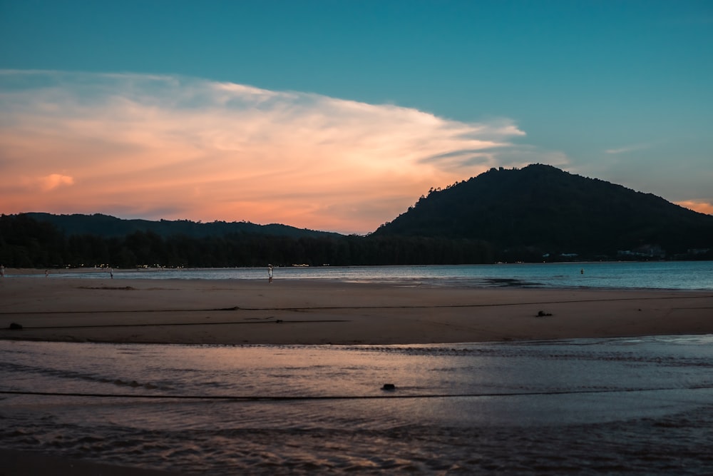 a beach with a mountain in the background