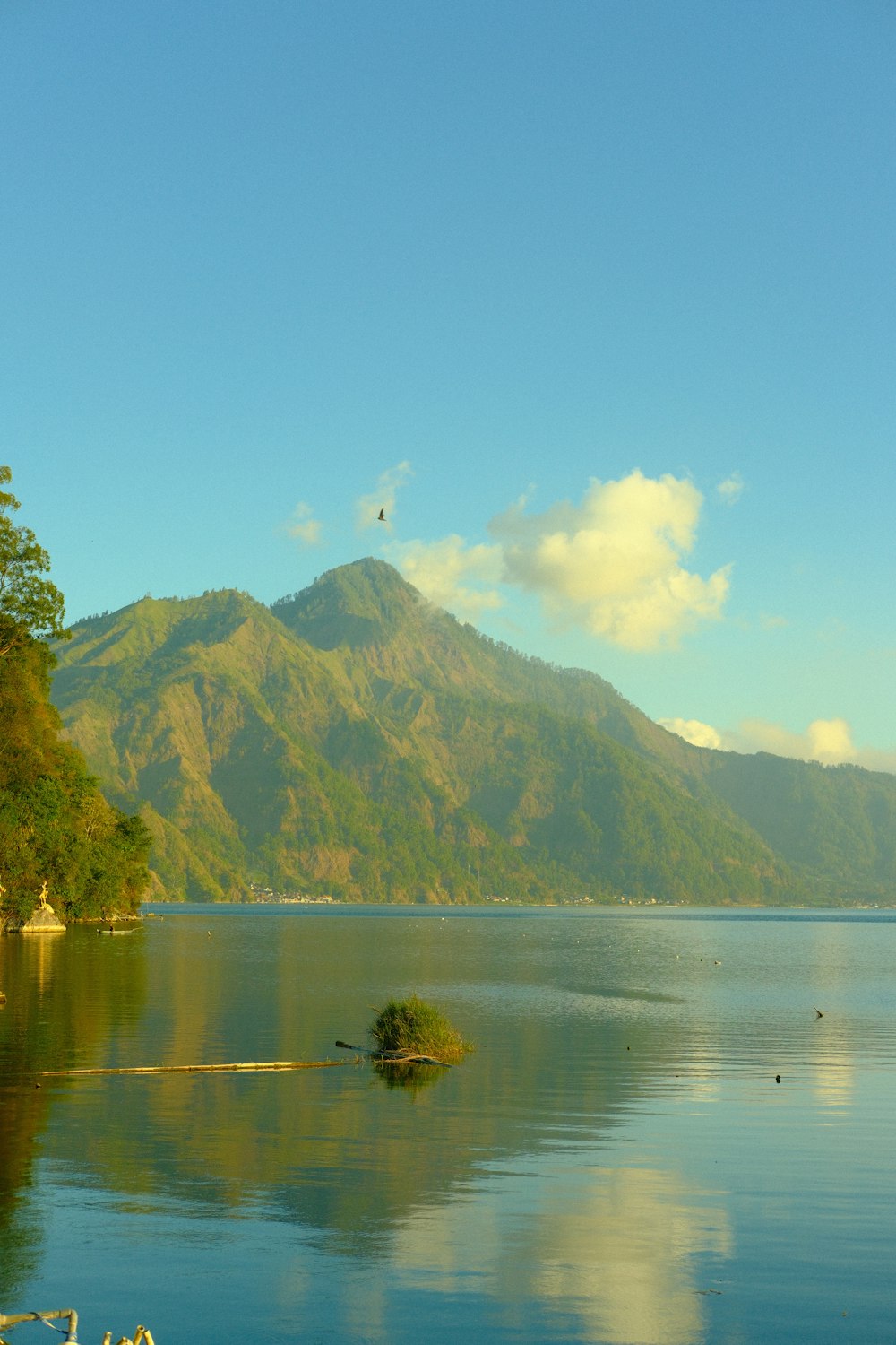 a large body of water with a mountain in the background