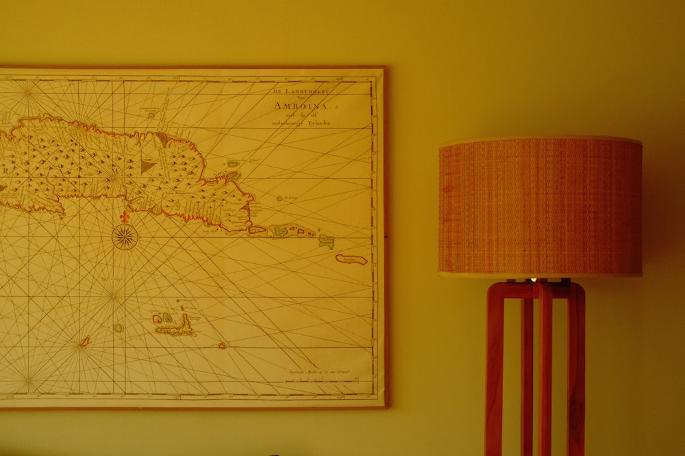 a map on a wall next to a lamp