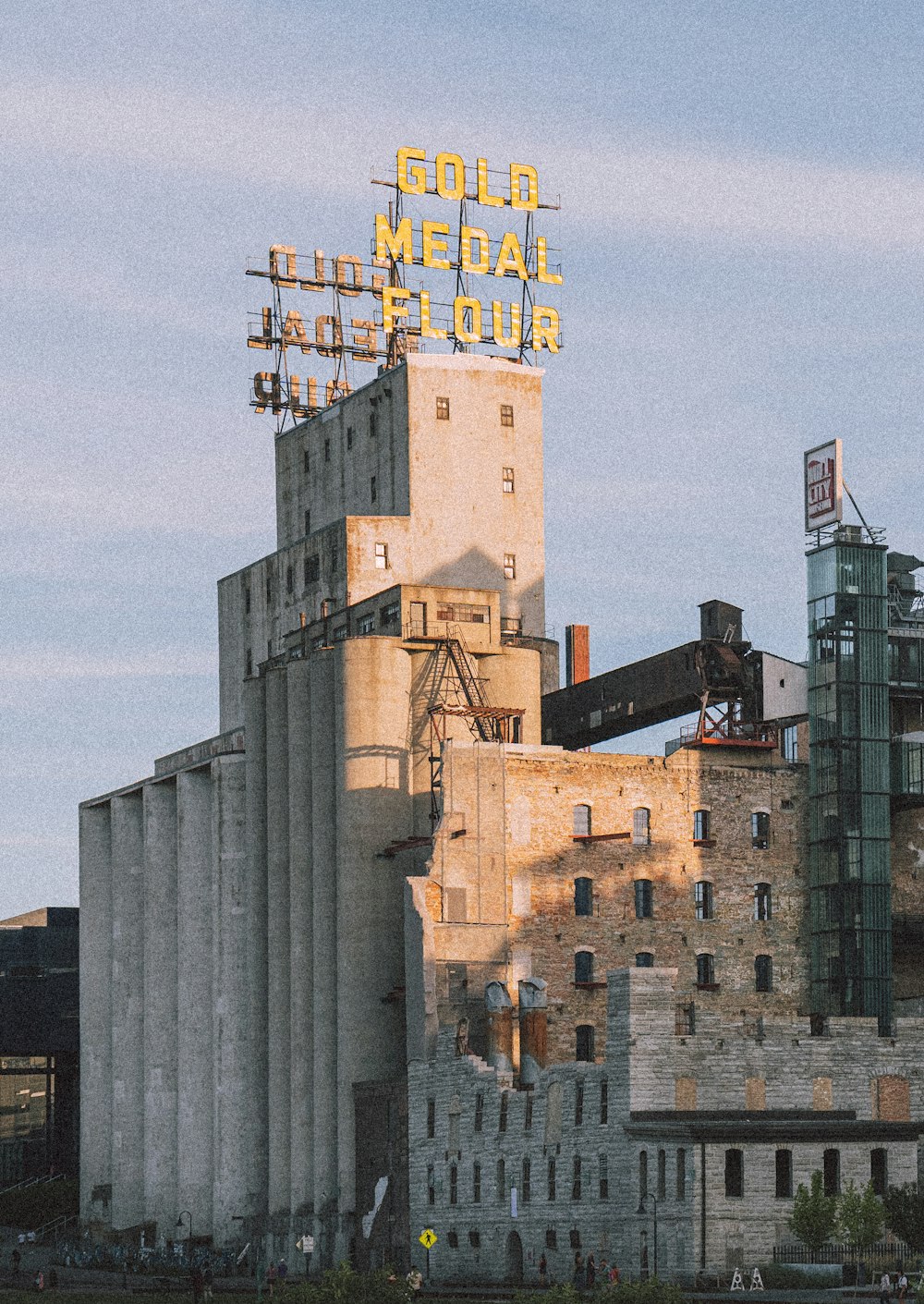 a tall building with a neon sign on top of it