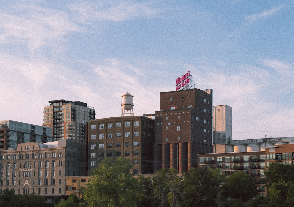 a city skyline with buildings and a water tower