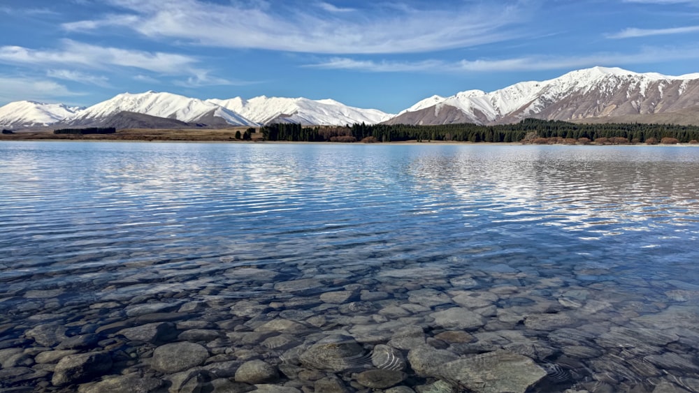 a body of water with mountains in the background