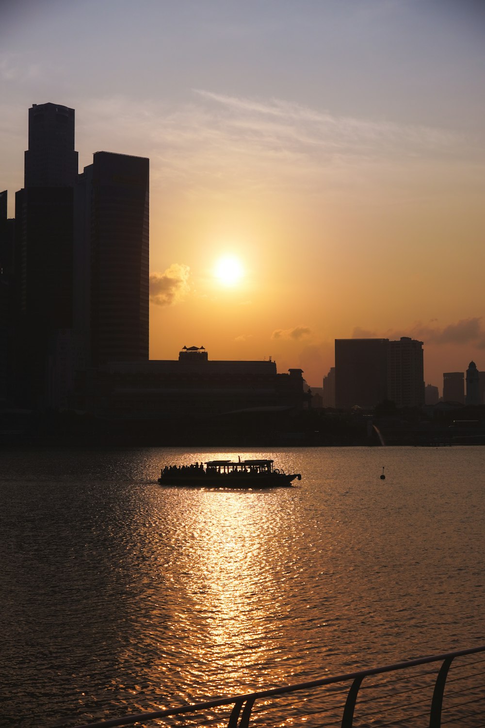 a boat on a body of water with a city in the background