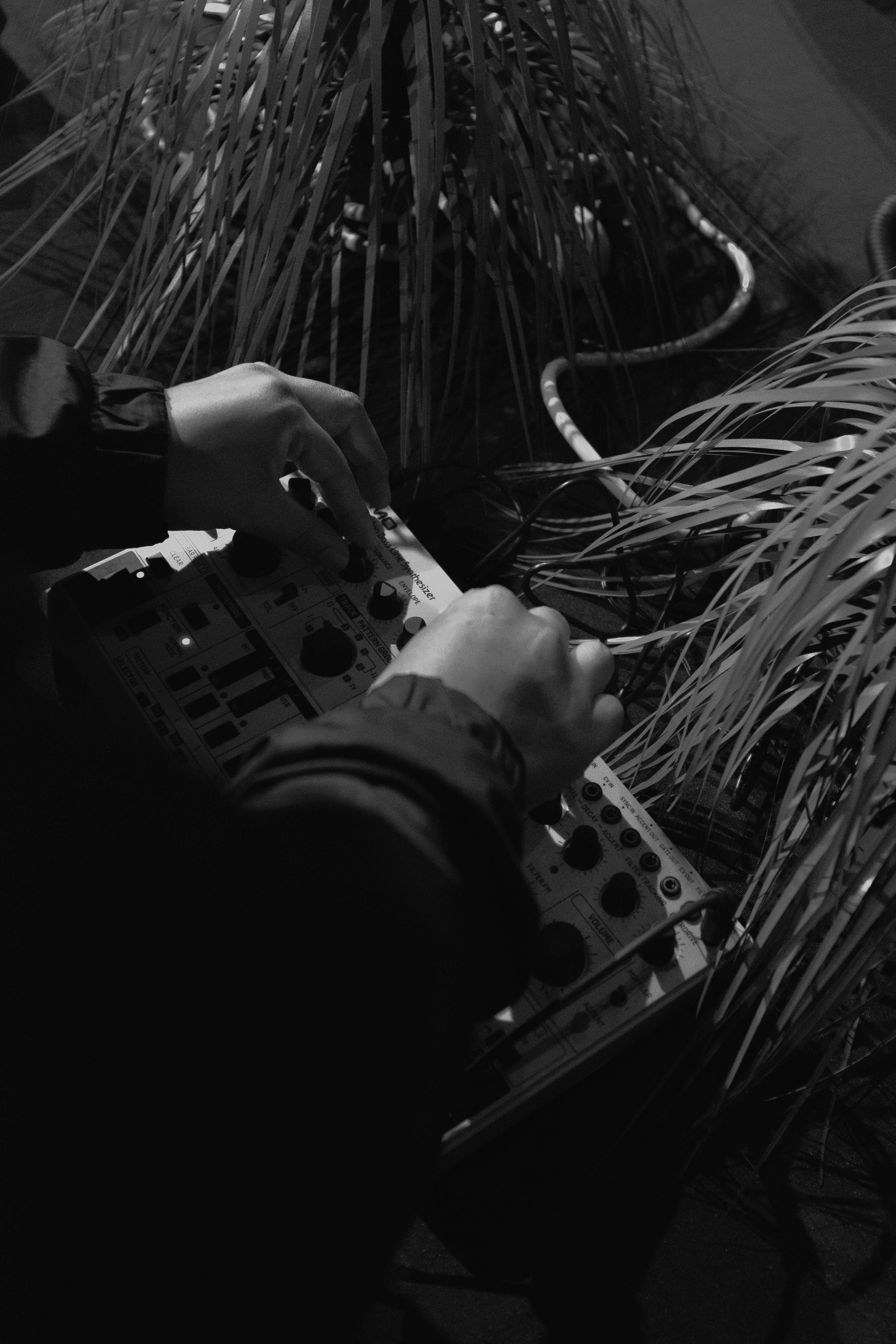a black and white photo of a person holding a controller