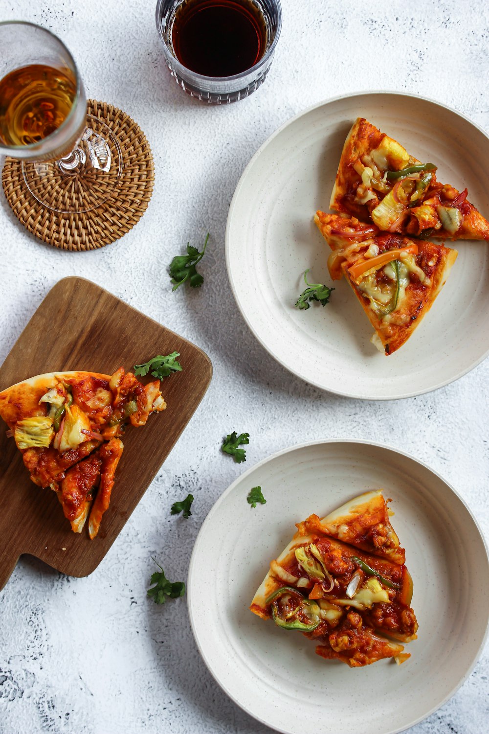 three slices of pizza sitting on top of white plates