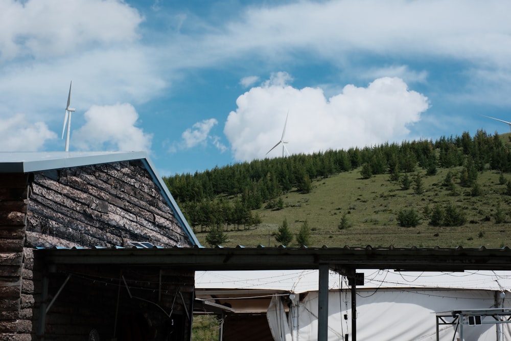 a house with a wind turbine in the background