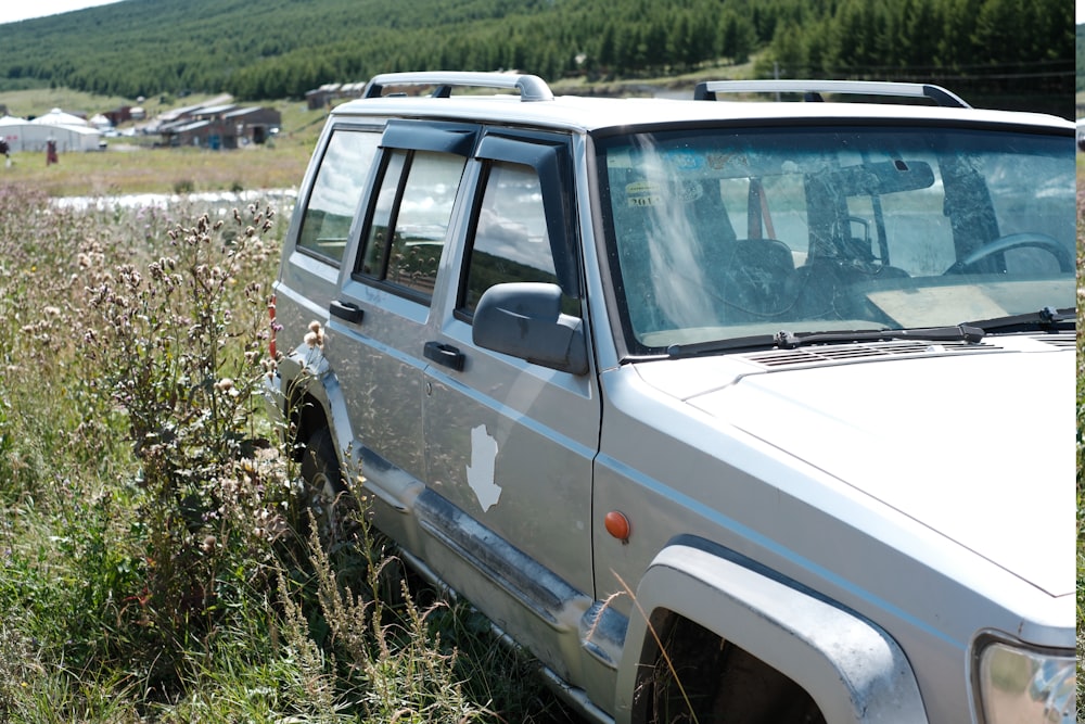 a jeep parked in a field of tall grass