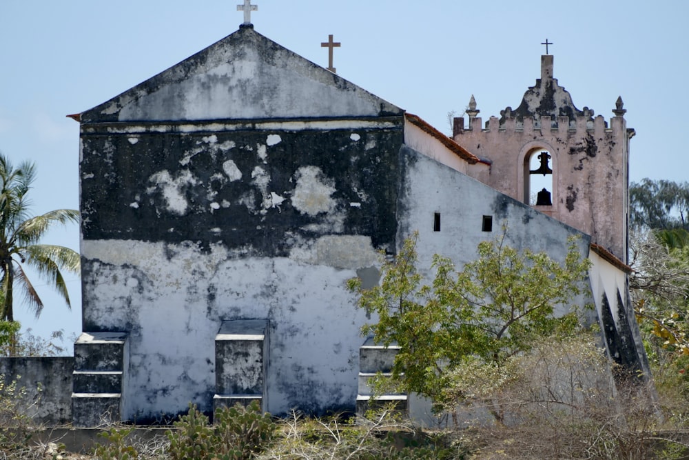 an old church with a cross on the top of it