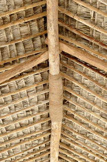 Close-up of hands building a sustainable shelter with natural materials