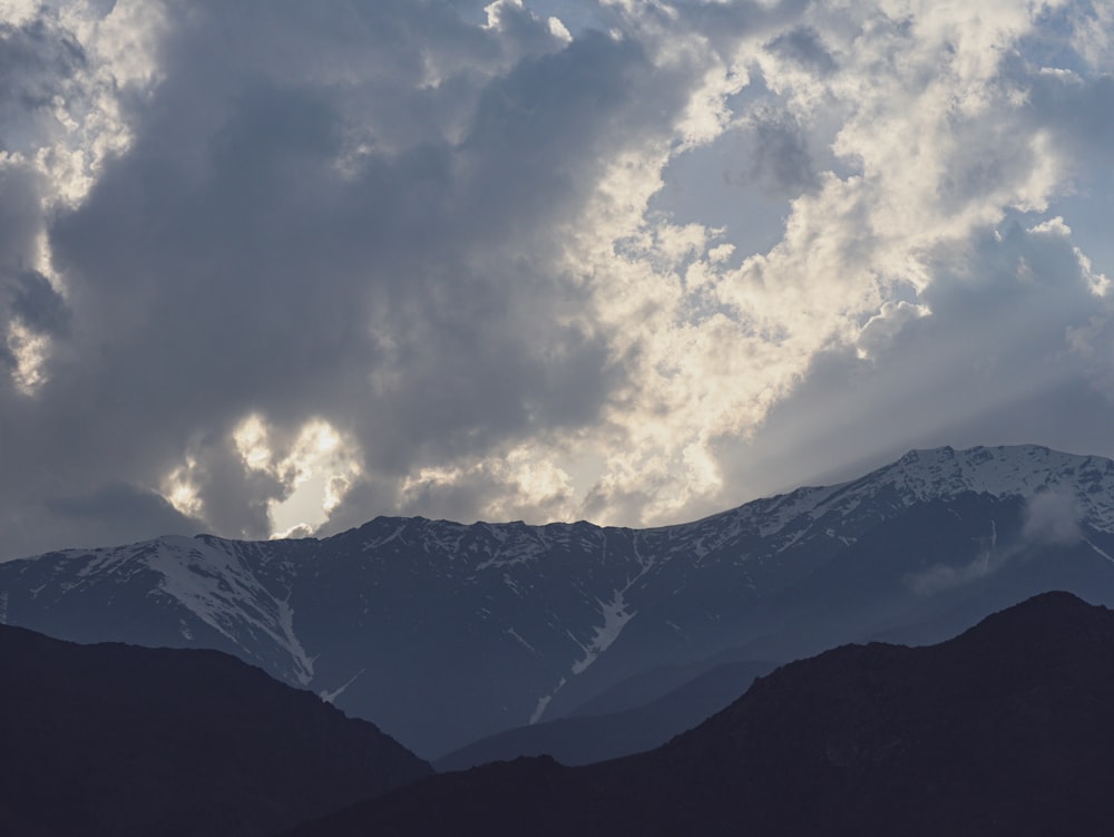 a view of a mountain range under a cloudy sky