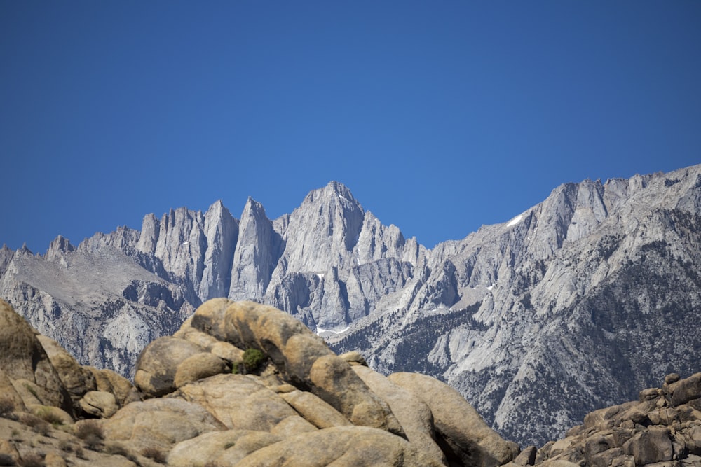 a view of a mountain range from a rocky area