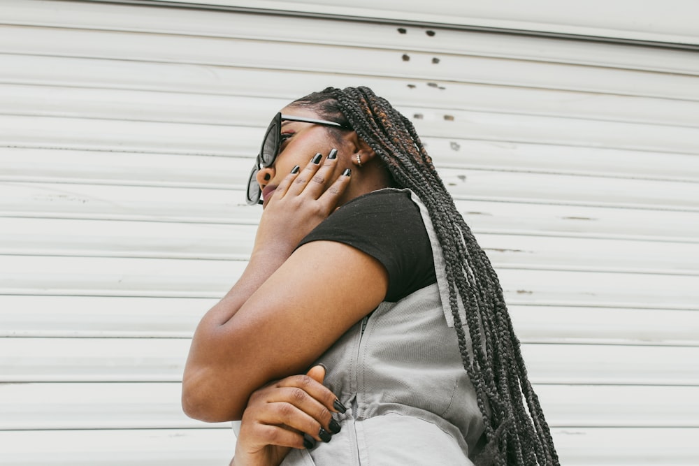 a woman with dreadlocks talking on a cell phone