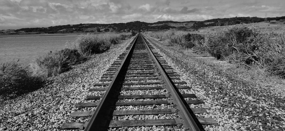 a black and white photo of a train track