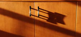 a wooden cabinet with a metal handle on it