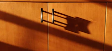 a wooden cabinet with a metal handle on it