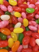 Sugar-coated jelly beans scattered on a surface.