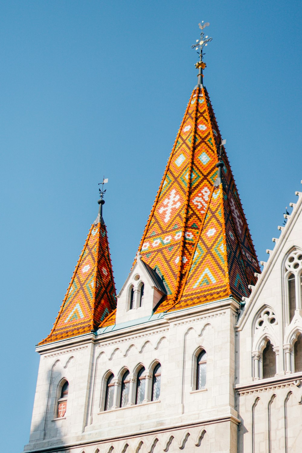 un grand bâtiment avec deux tours et une croix au sommet