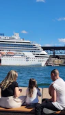 Happy family enjoying a scenic cruise deck view with ocean waves and clear sunny weather