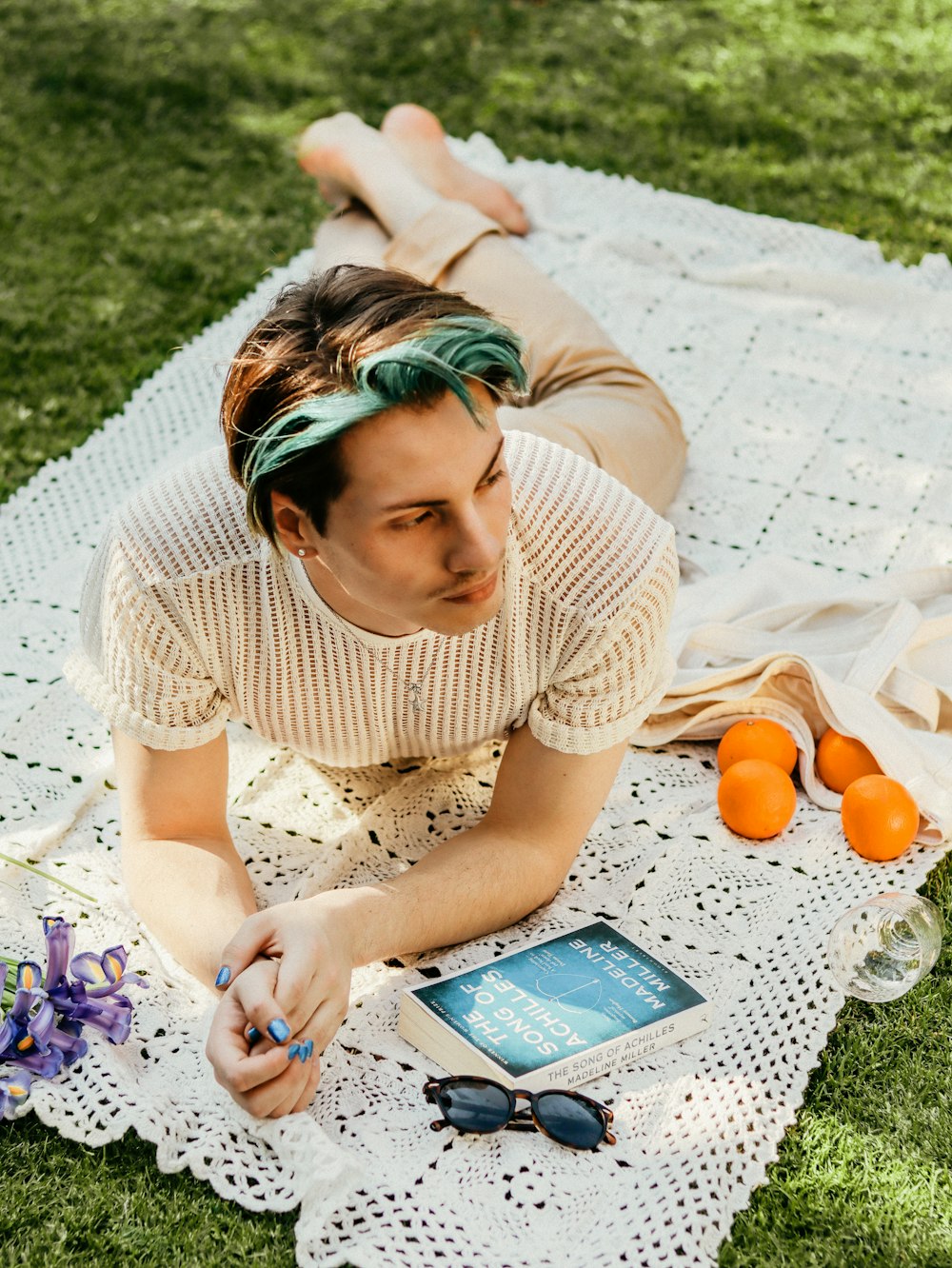 a woman laying on a blanket next to an orange