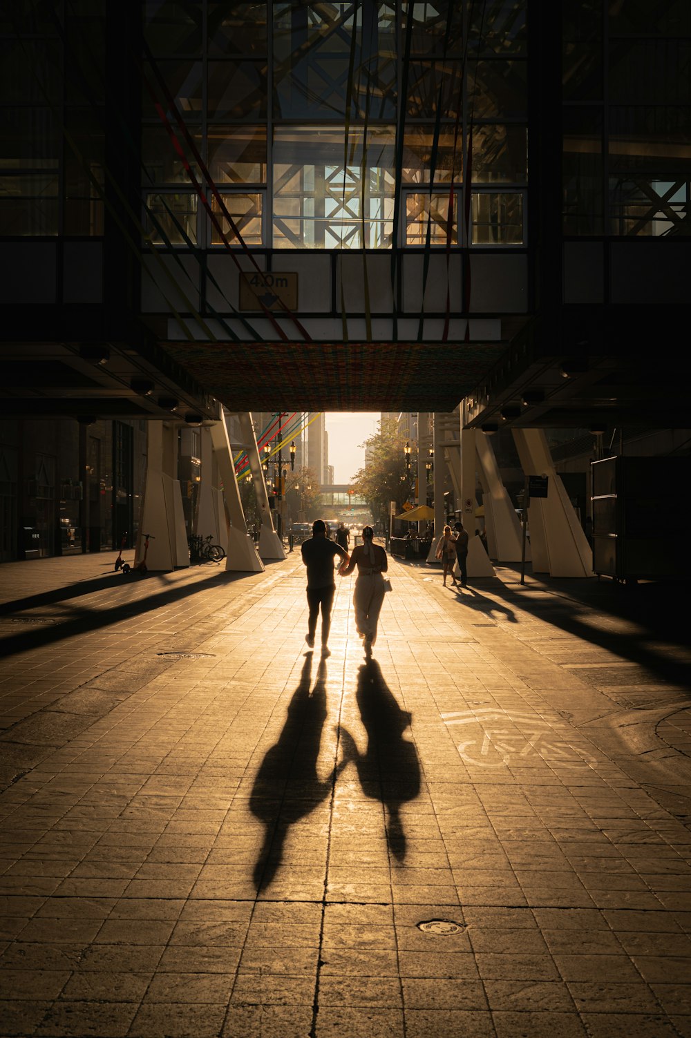 a couple of people that are walking down a street