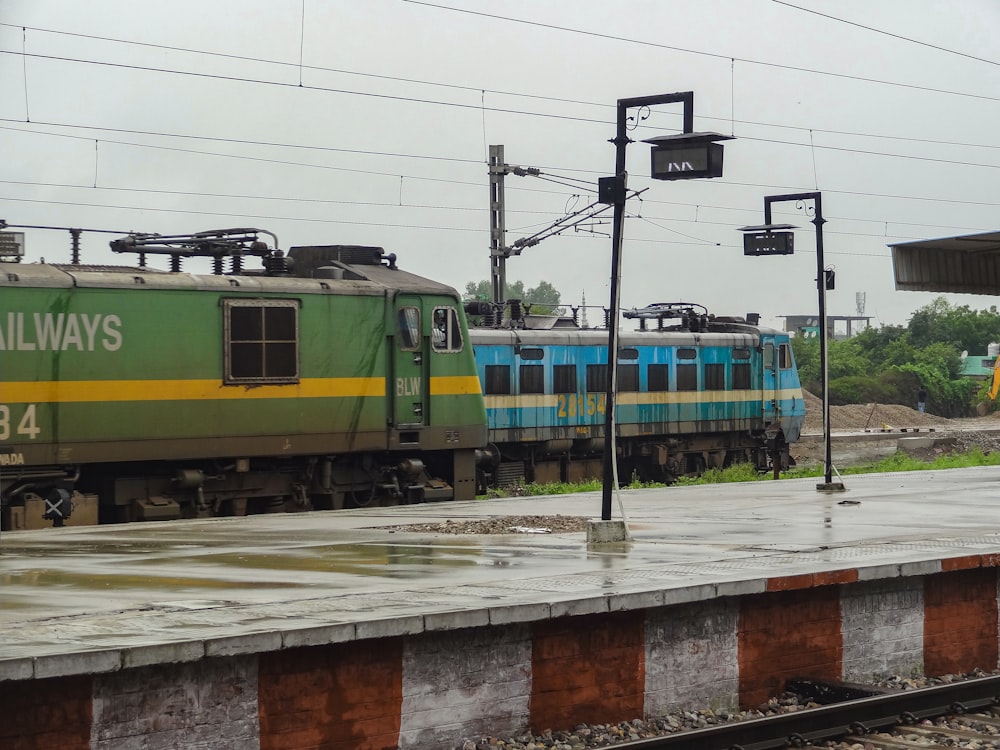 a train traveling down tracks next to a train station