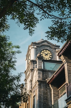 a tall clock tower with a clock on each of it's sides