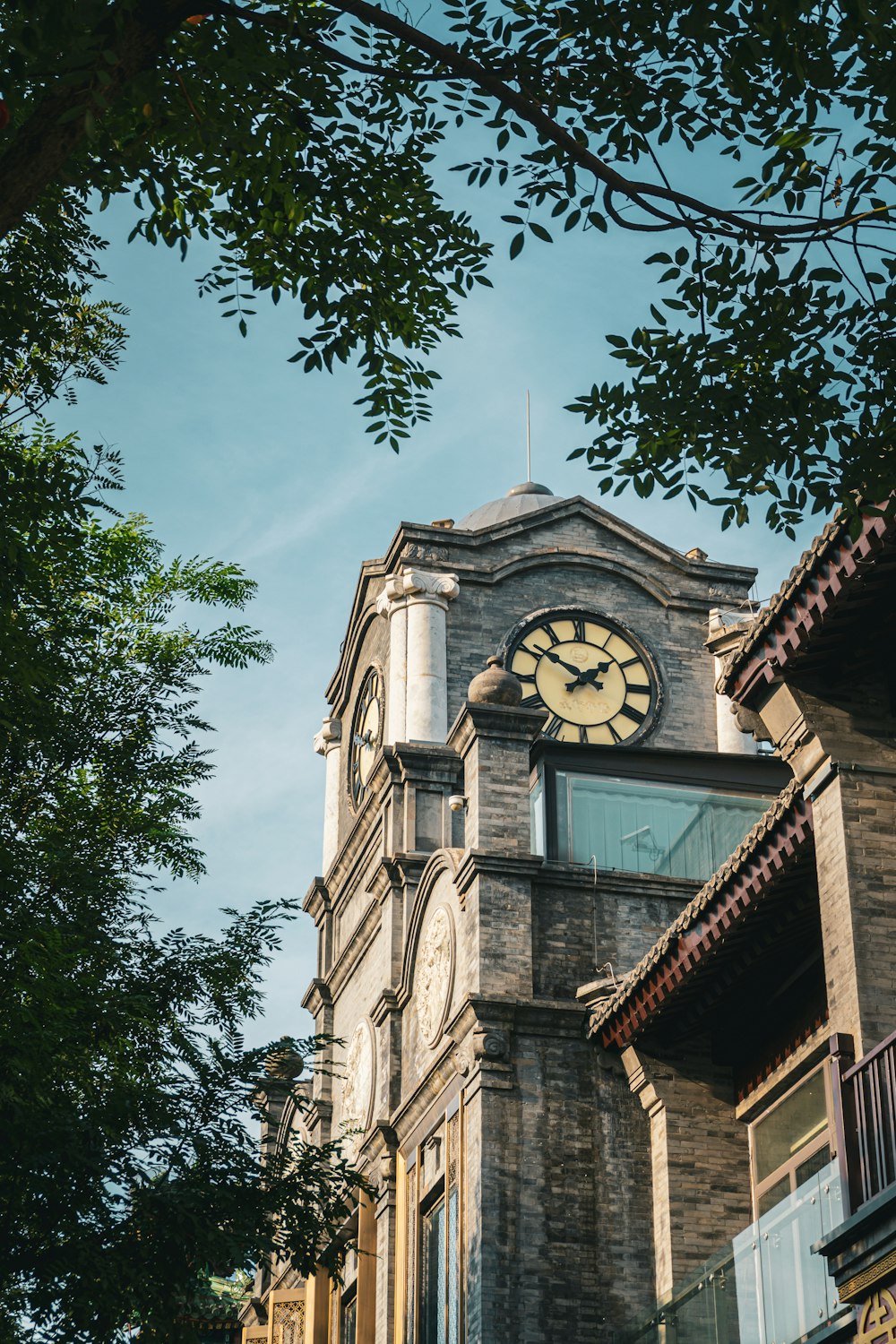 a tall clock tower with a clock on each of it's sides