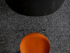 an orange plate sitting on top of a black table