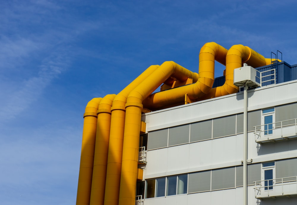 a building with yellow pipes on top of it