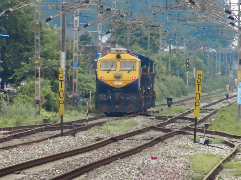 a yellow and blue train traveling down train tracks