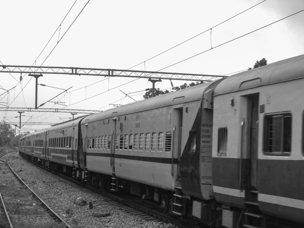 a black and white photo of a train on the tracks