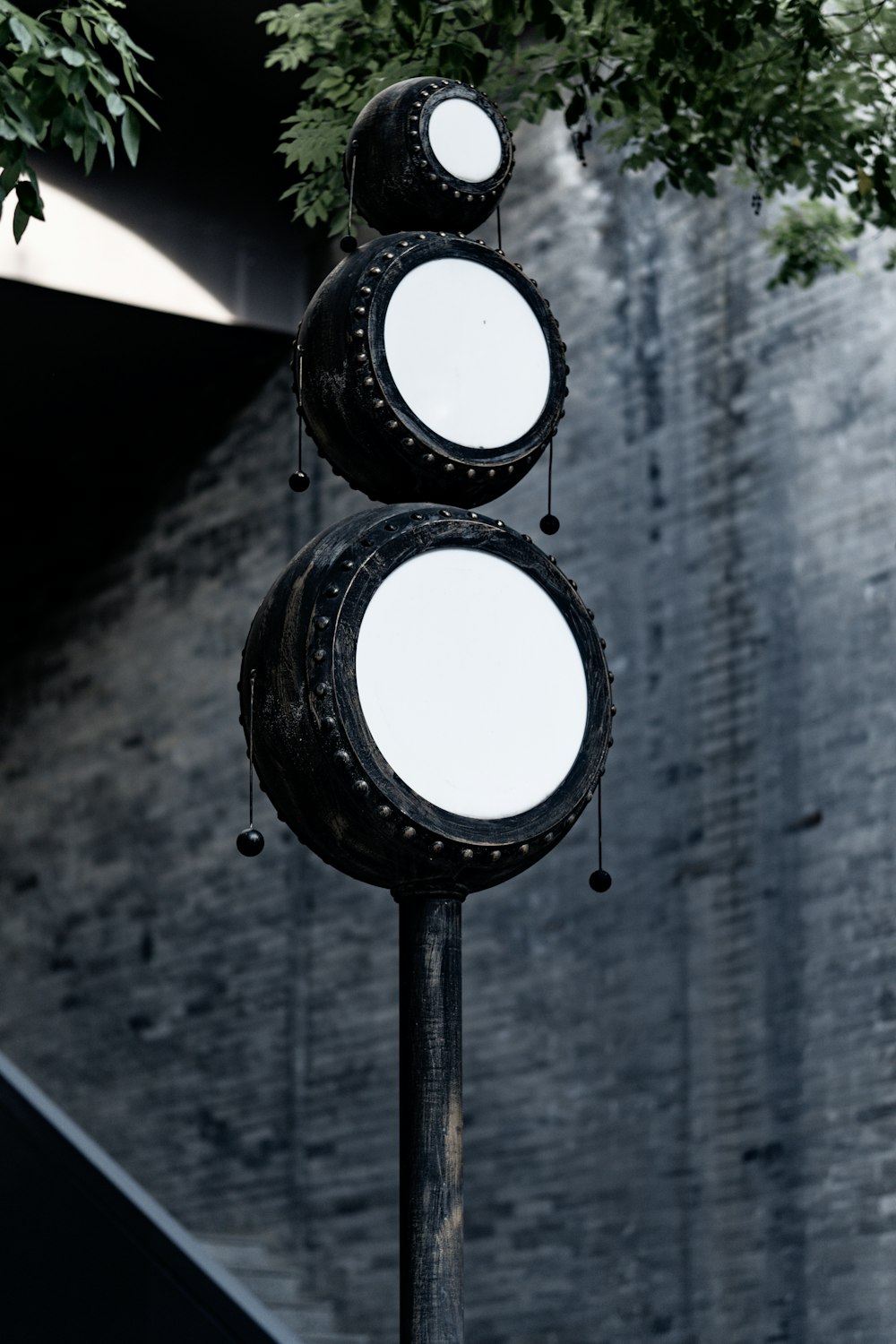 a pole with three round mirrors on top of it