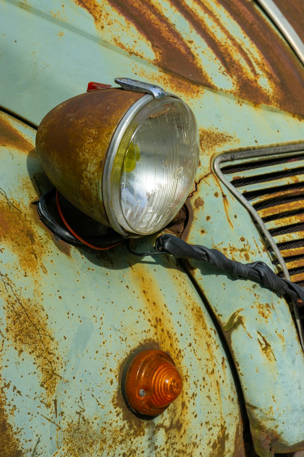 a rusted out car with a light on it