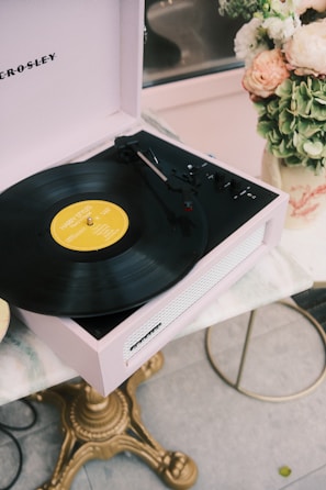 An acrylic record player stand holding vinyl records with elegance.