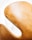 A close-up view of a sleek, curved chair with a light tan, leather-like texture, highlighting its elegant design against a bright white background.