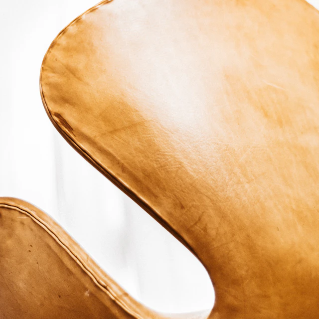 A close up of a brown leather chair