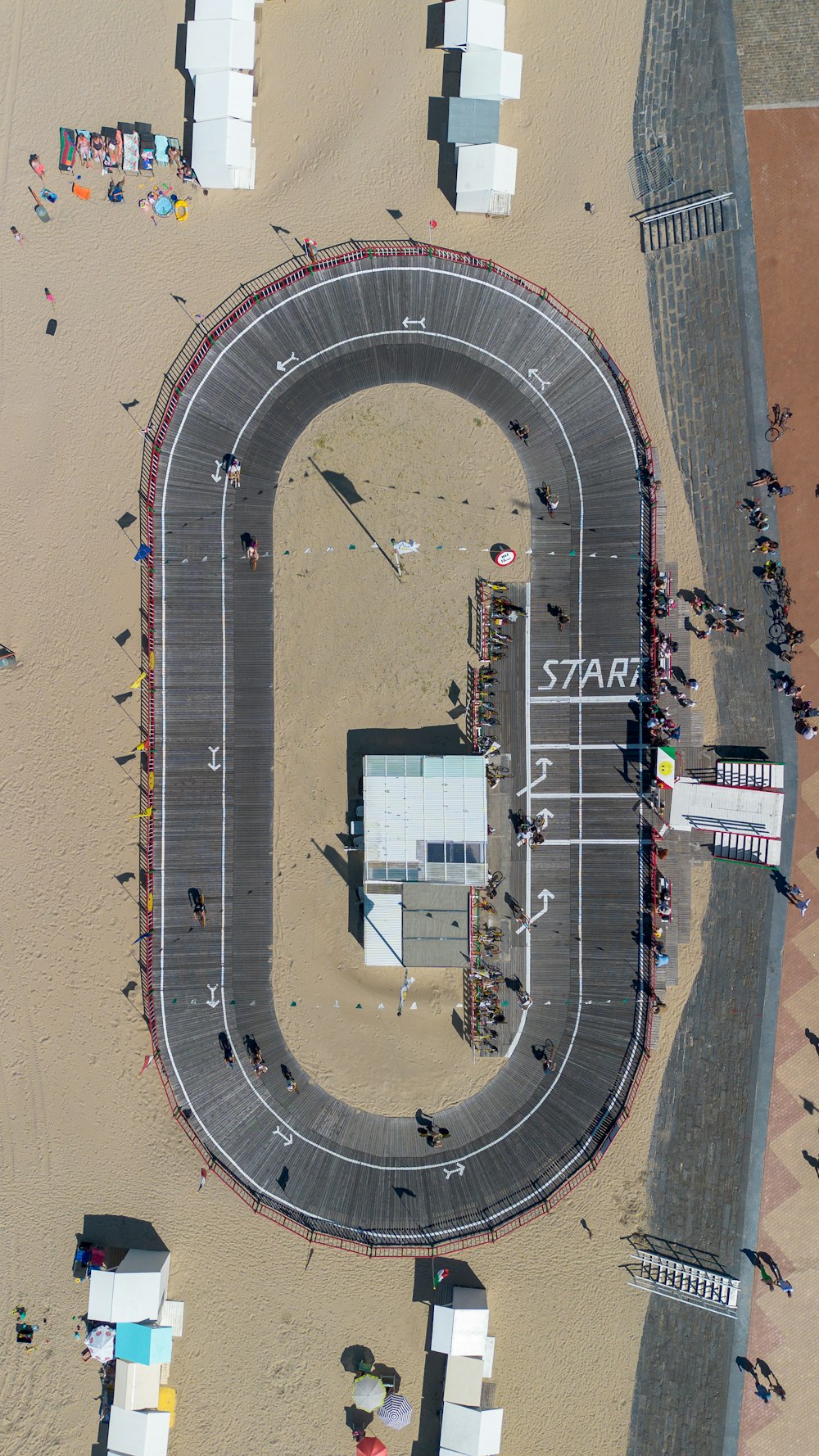 an aerial view of a race track in the middle of a beach