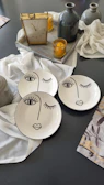 Elegant silver and black home accessory set arranged on a light gray surface.