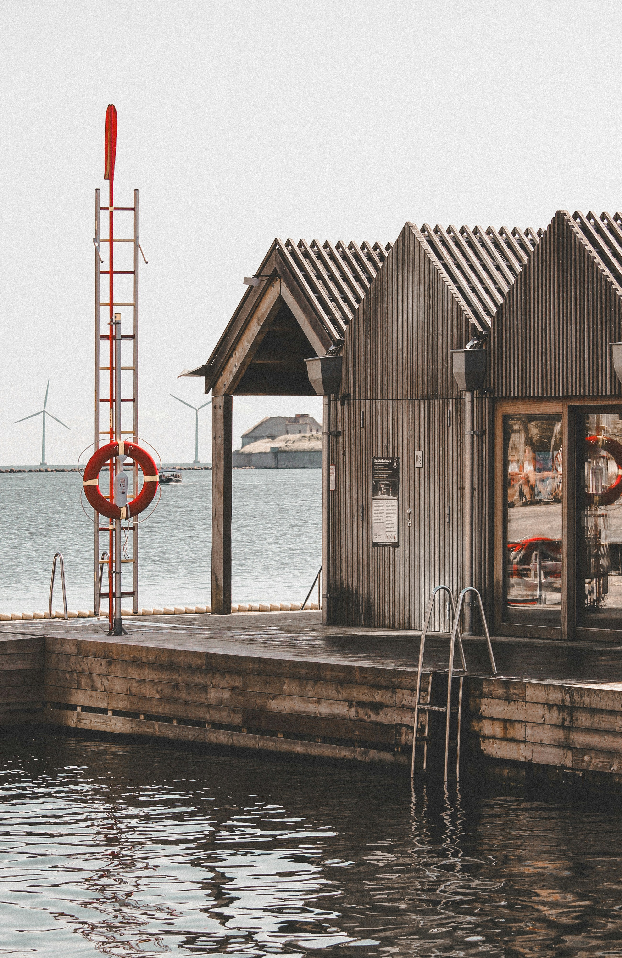 a boat dock with a boathouse and a life preserver