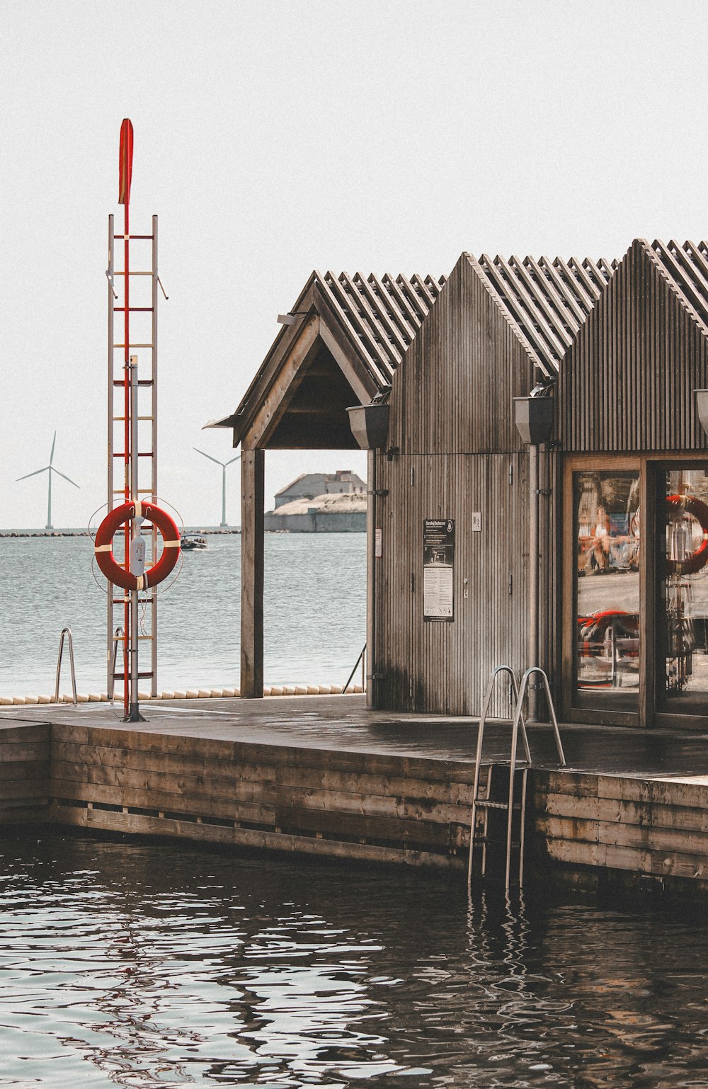 a boat dock with a boathouse and a life preserver