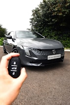 A happy customer receiving keys to a fuel-efficient hybrid rental car for gig work in Houston.