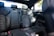 The interior of a modern car displaying the rear passenger seats. The seats are upholstered in black leather with a textured pattern in the center. The car appears to be clean and well-maintained, with the seat belts properly arranged.