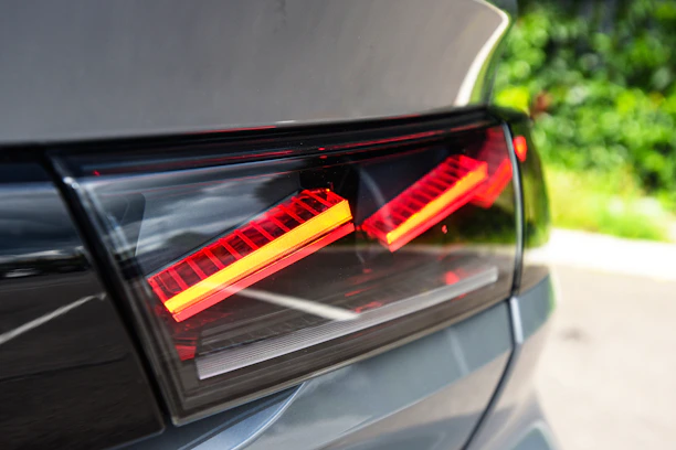 Happy customer installing LED tail lights on a modern car in a garage