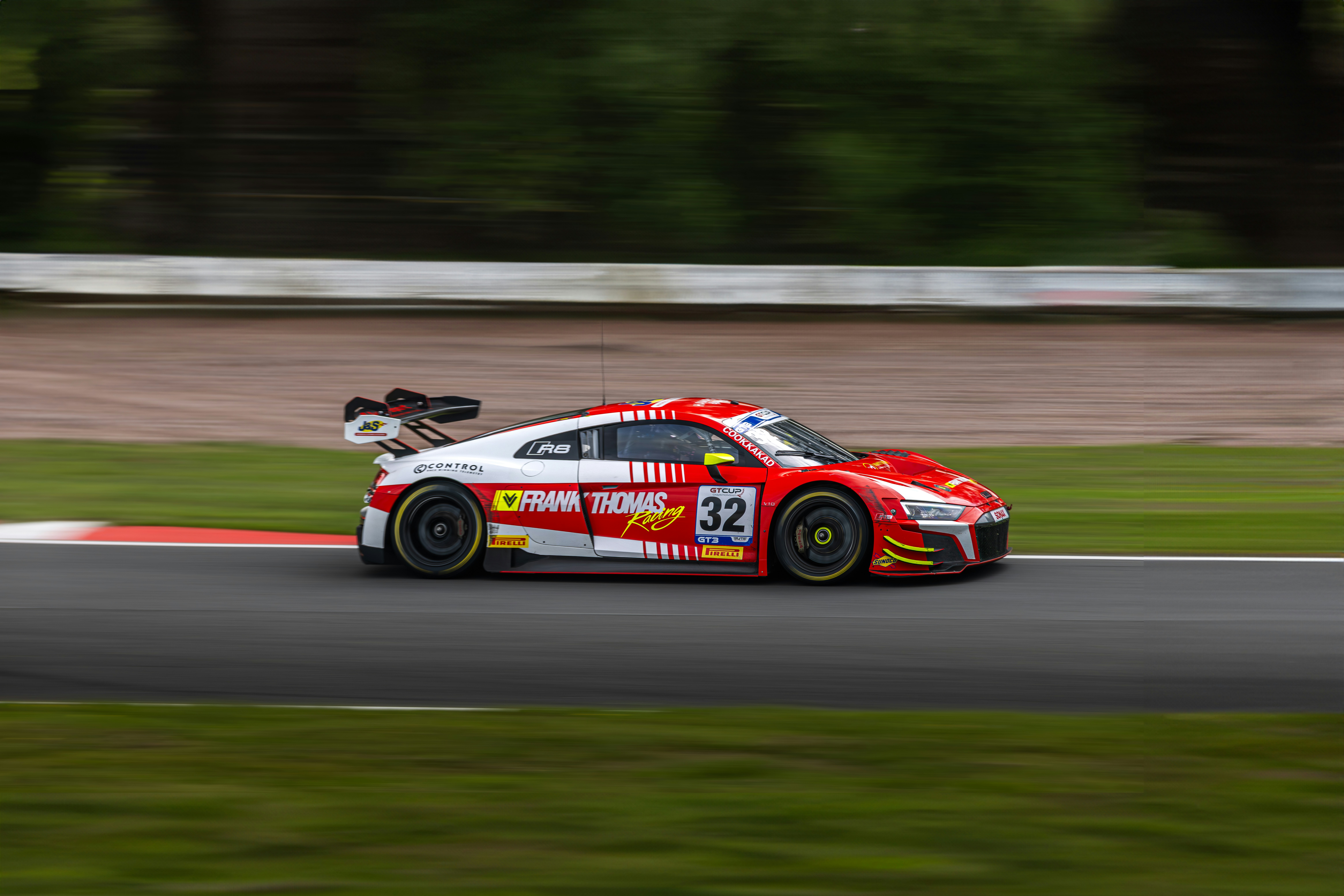 A race car driving down a race track photo – Free Oulton park circuit ...