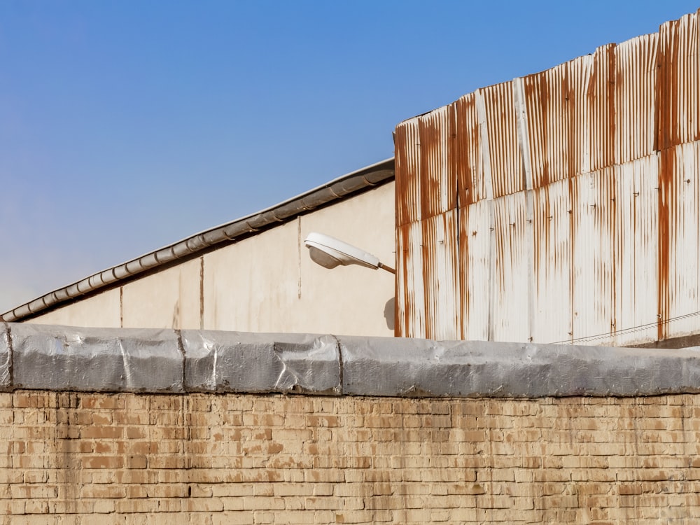 a brick wall with a metal fence on top of it