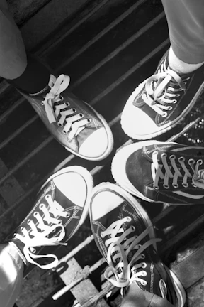 Vintage black and white photo of a group wearing All Star sneakers.