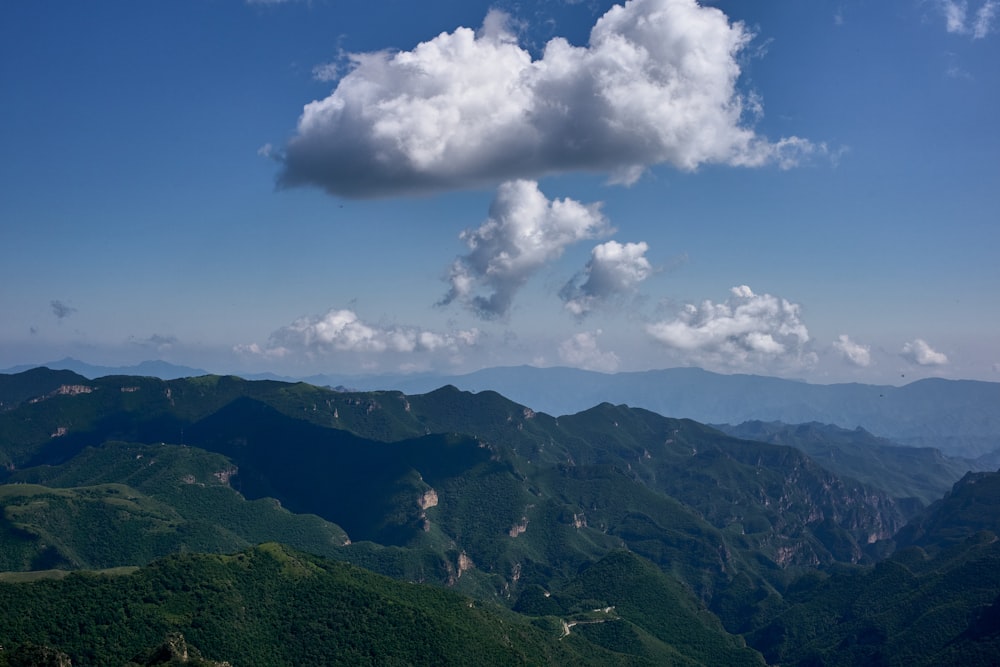 a view of a mountain range with a cloud in the sky