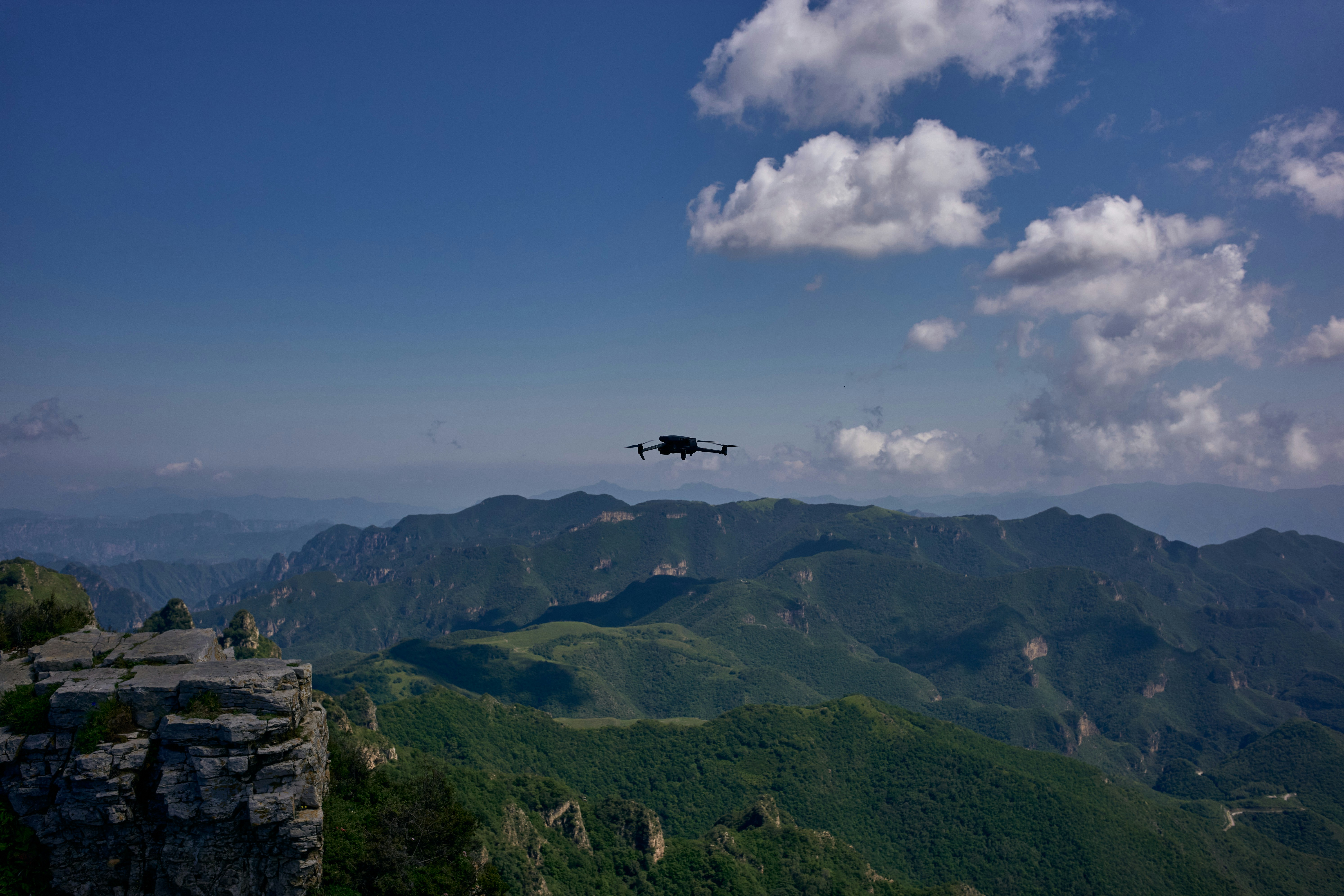 a plane is flying over a mountain range